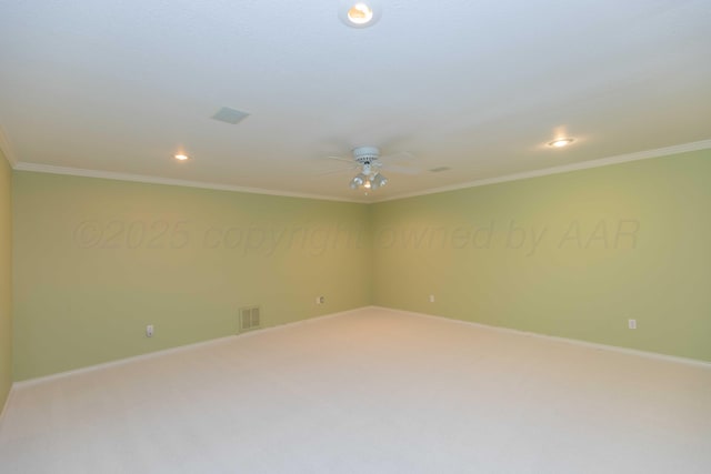 carpeted spare room with crown molding and ceiling fan