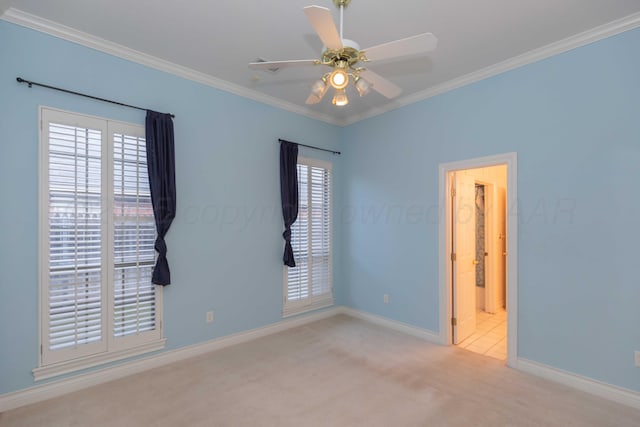 spare room with ceiling fan, ornamental molding, and light carpet