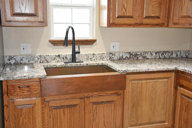 kitchen with sink and light stone counters