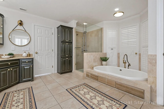 7715 Tarrytown Ave, Amarillo, TX 79121 - bathroom with vanity, ornamental molding, a garden tub, a stall shower, and tile patterned floors