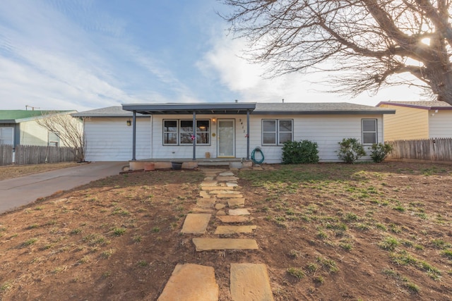 ranch-style home with a porch and fence