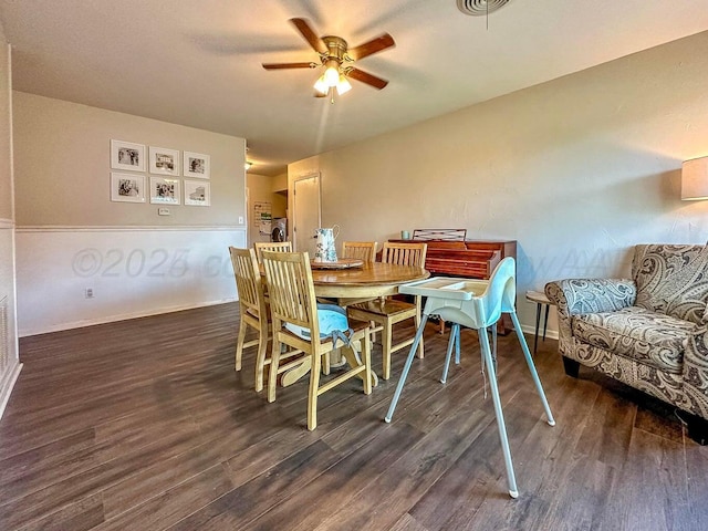 dining room with ceiling fan and dark wood-type flooring