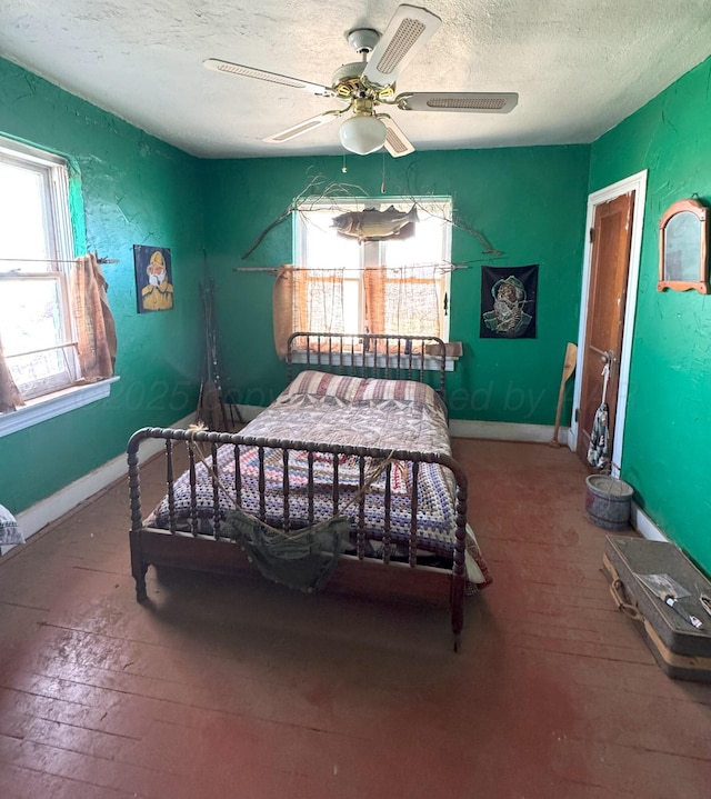 bedroom with a textured ceiling and ceiling fan