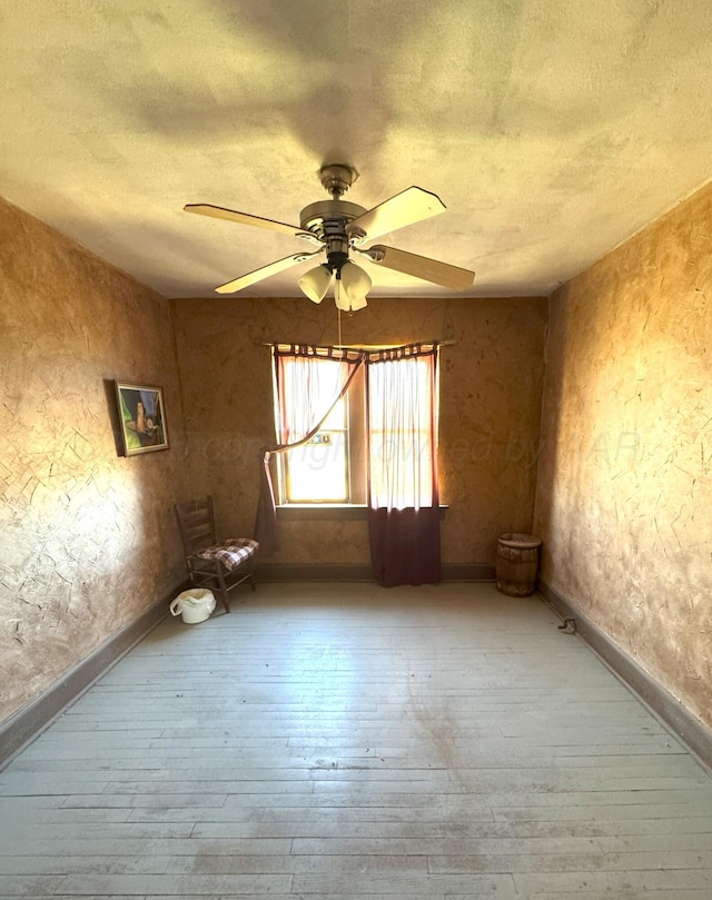 spare room featuring hardwood / wood-style flooring and ceiling fan