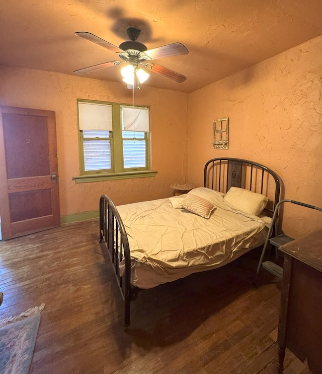 bedroom featuring ceiling fan and dark wood-type flooring