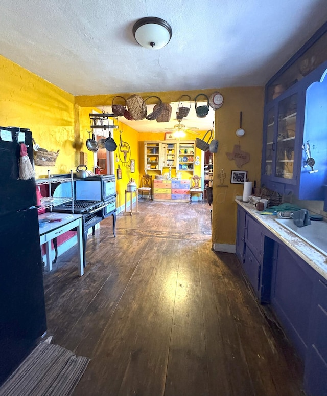 interior space with a textured ceiling and dark hardwood / wood-style flooring