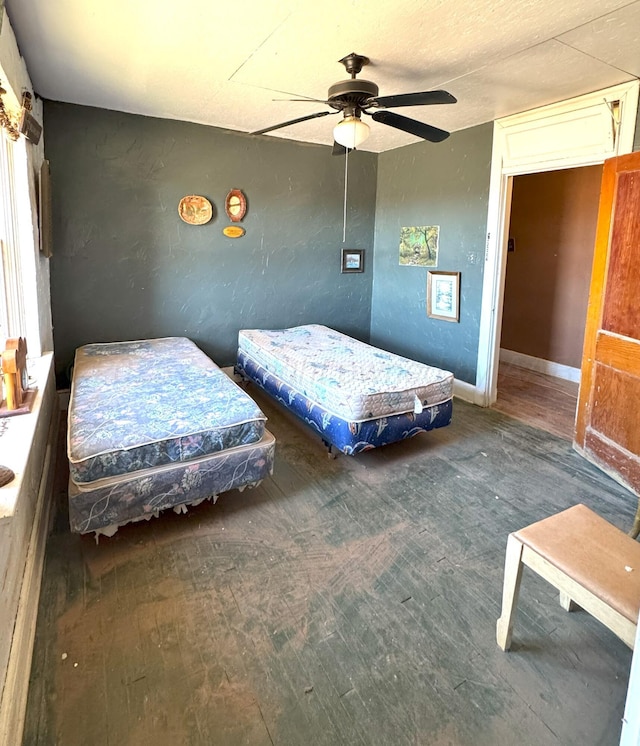 bedroom with ceiling fan and dark hardwood / wood-style flooring