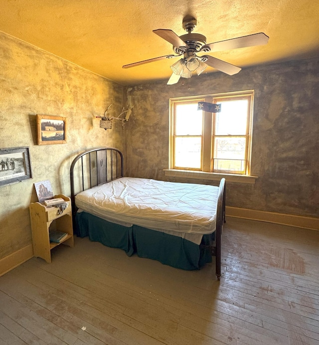 bedroom with ceiling fan and wood-type flooring