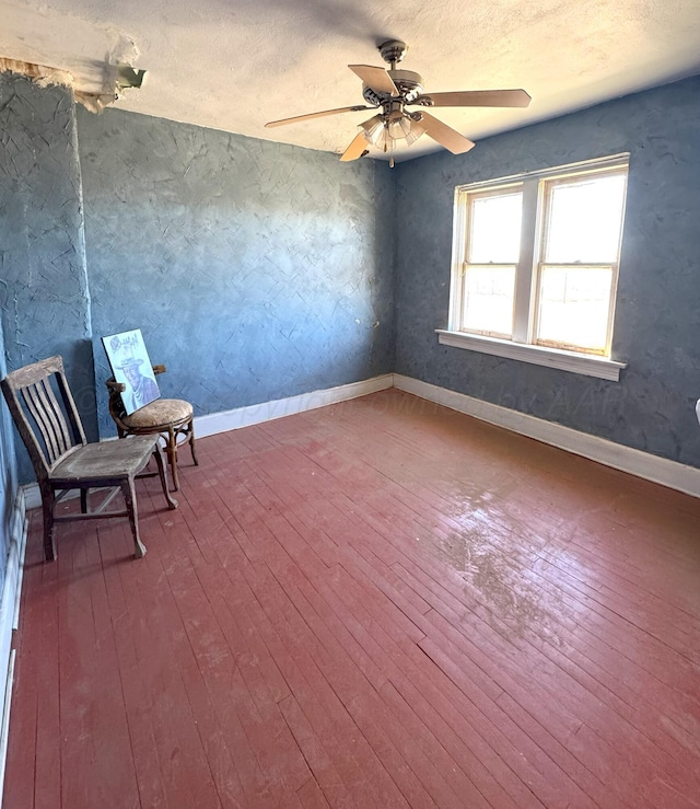 unfurnished room with ceiling fan and wood-type flooring