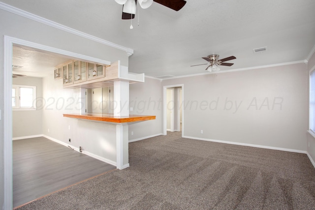 1928 Cherry St, Amarillo, TX 79106 - unfurnished room with ceiling fan, crown molding, and dark carpet