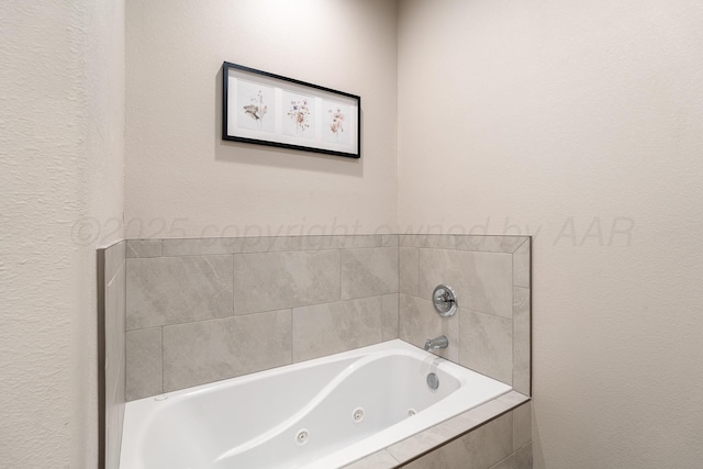 bathroom with a tub with jets