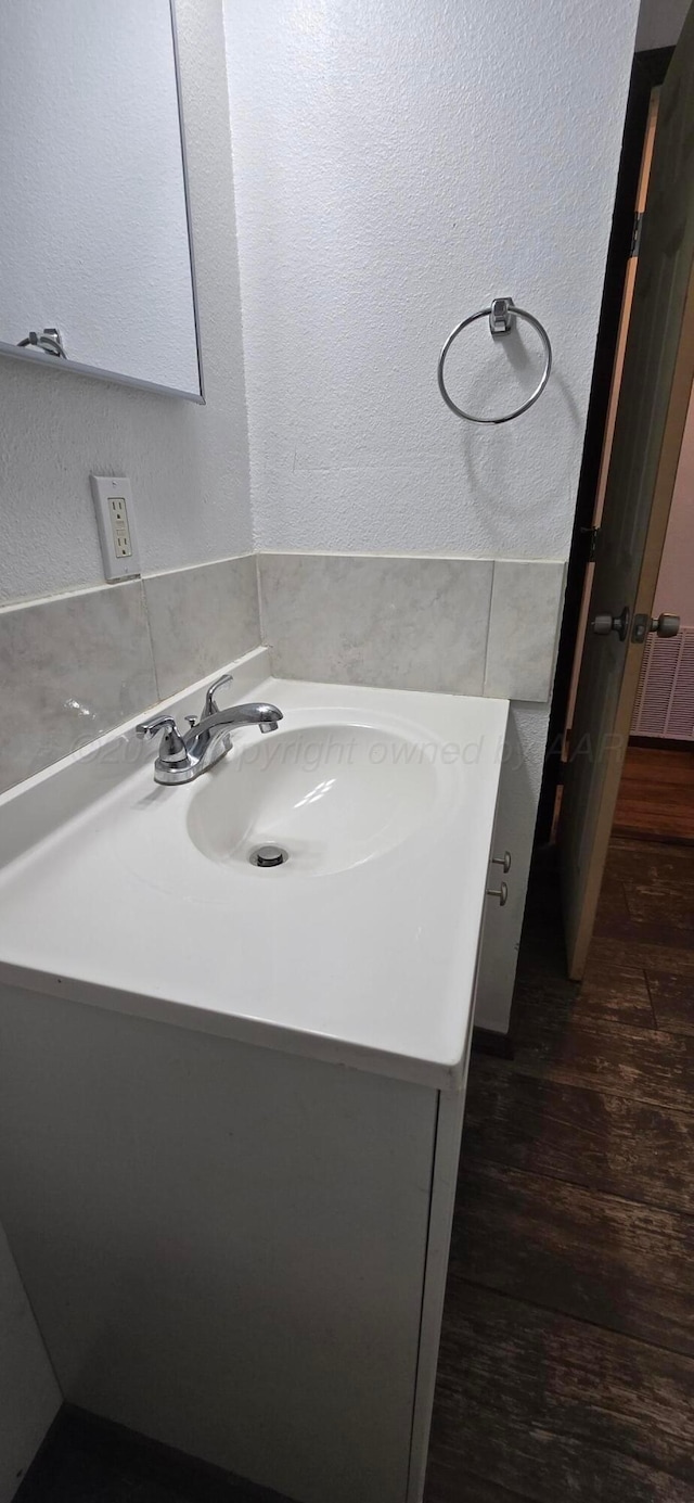 bathroom featuring vanity and hardwood / wood-style flooring