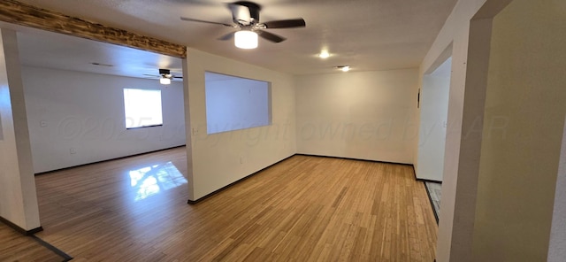 spare room with ceiling fan and light wood-type flooring