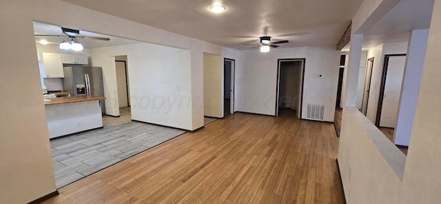 unfurnished living room featuring ceiling fan