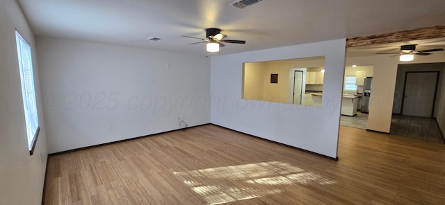 spare room featuring hardwood / wood-style floors and ceiling fan