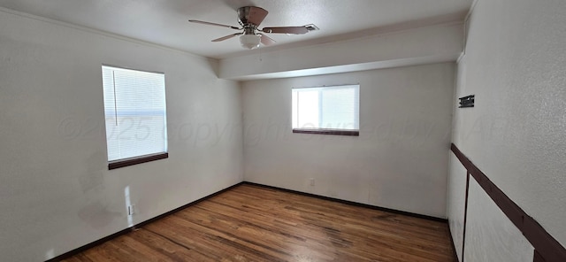 empty room featuring ceiling fan and hardwood / wood-style floors