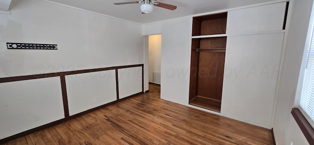 unfurnished bedroom featuring a closet, dark hardwood / wood-style floors, and ceiling fan