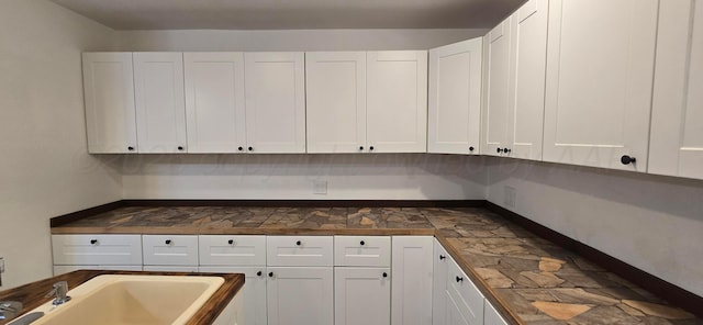 interior space featuring white cabinets and sink