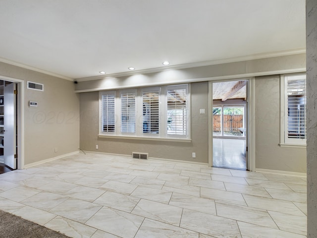 empty room featuring baseboards, ornamental molding, visible vents, and recessed lighting