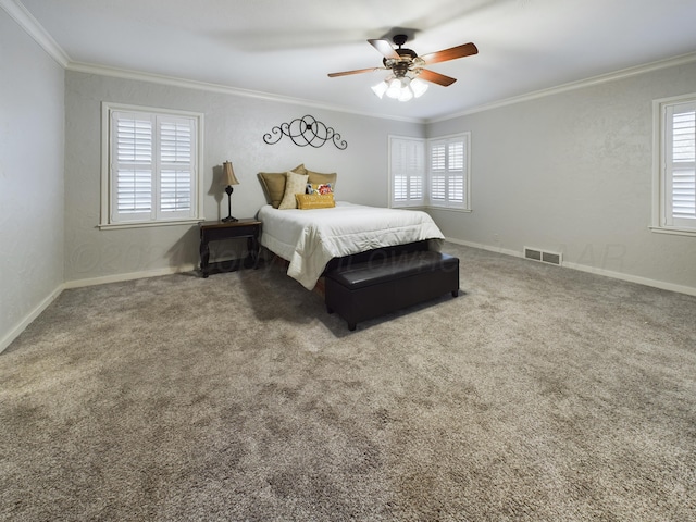 carpeted bedroom featuring a ceiling fan, ornamental molding, baseboards, and visible vents
