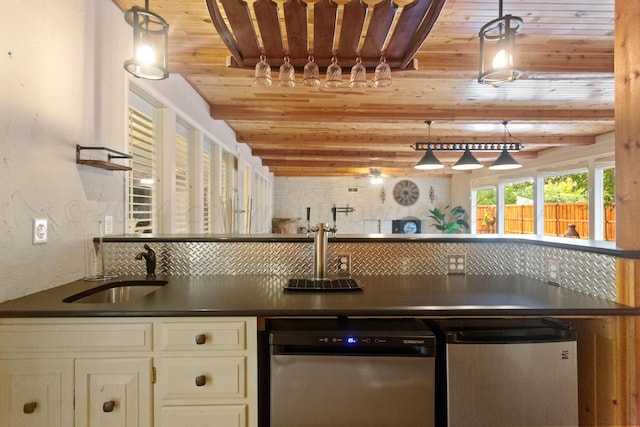 kitchen featuring a sink, dark countertops, and tasteful backsplash