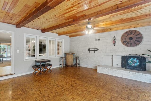 living area with wooden ceiling, baseboards, beamed ceiling, visible vents, and ceiling fan