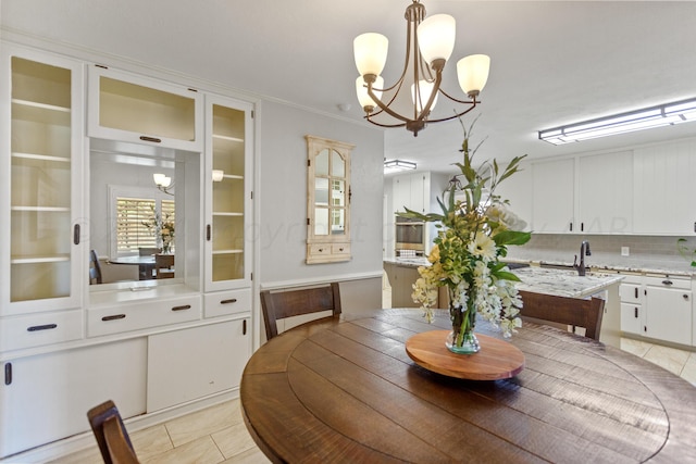 dining room featuring light tile patterned floors and a chandelier