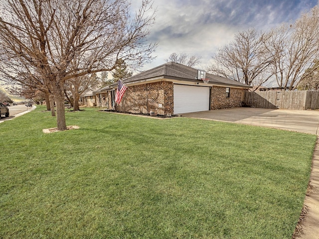 view of side of home featuring a garage and a lawn