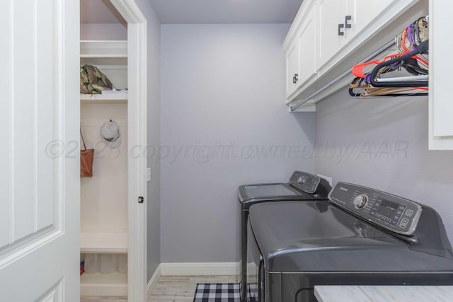 laundry room with cabinets and separate washer and dryer