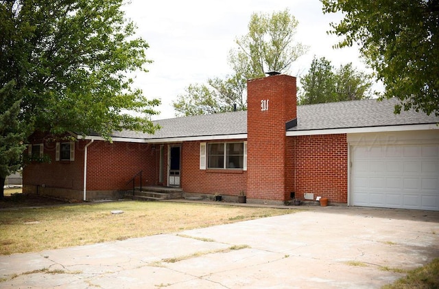 single story home featuring a garage and a front yard