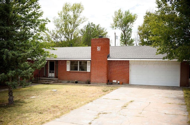 single story home featuring a garage and a front lawn