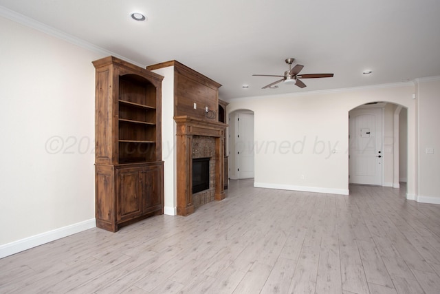 9407 Kori Dr, Amarillo, TX 79119 - unfurnished living room with ceiling fan, arched walkways, baseboards, a glass covered fireplace, and ornamental molding