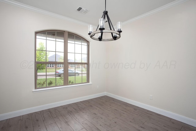 9407 Kori Dr, Amarillo, TX 79119 - spare room with a chandelier, visible vents, baseboards, ornamental molding, and wood finished floors