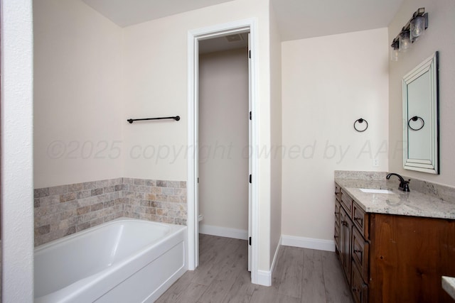 9407 Kori Dr, Amarillo, TX 79119 - bathroom with vanity, a bath, toilet, baseboards, and wood finished floors