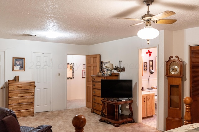 interior space with ceiling fan, a textured ceiling, and light colored carpet