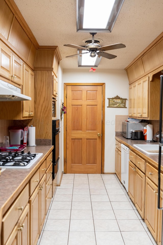 kitchen featuring light tile patterned floors, a textured ceiling, white appliances, and ceiling fan