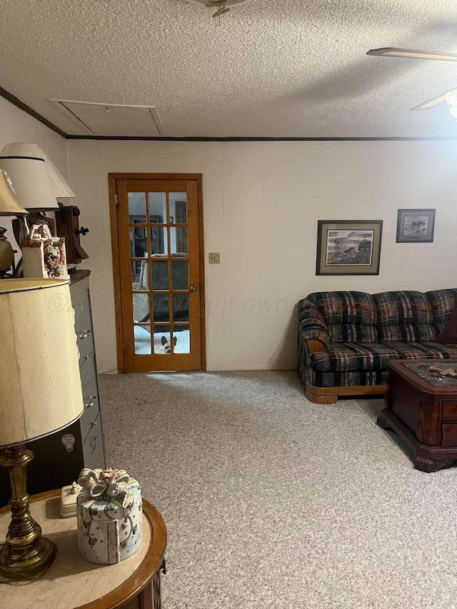 living room featuring a textured ceiling, ceiling fan, and carpet floors