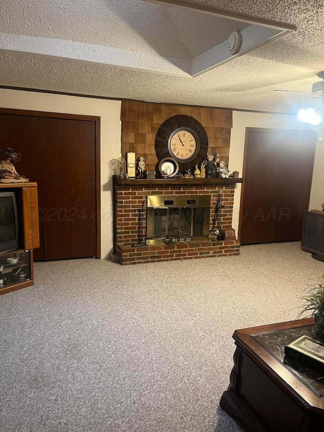 living room featuring wooden walls, a textured ceiling, carpet, and a fireplace