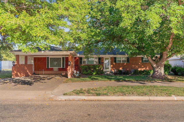 ranch-style house featuring a carport