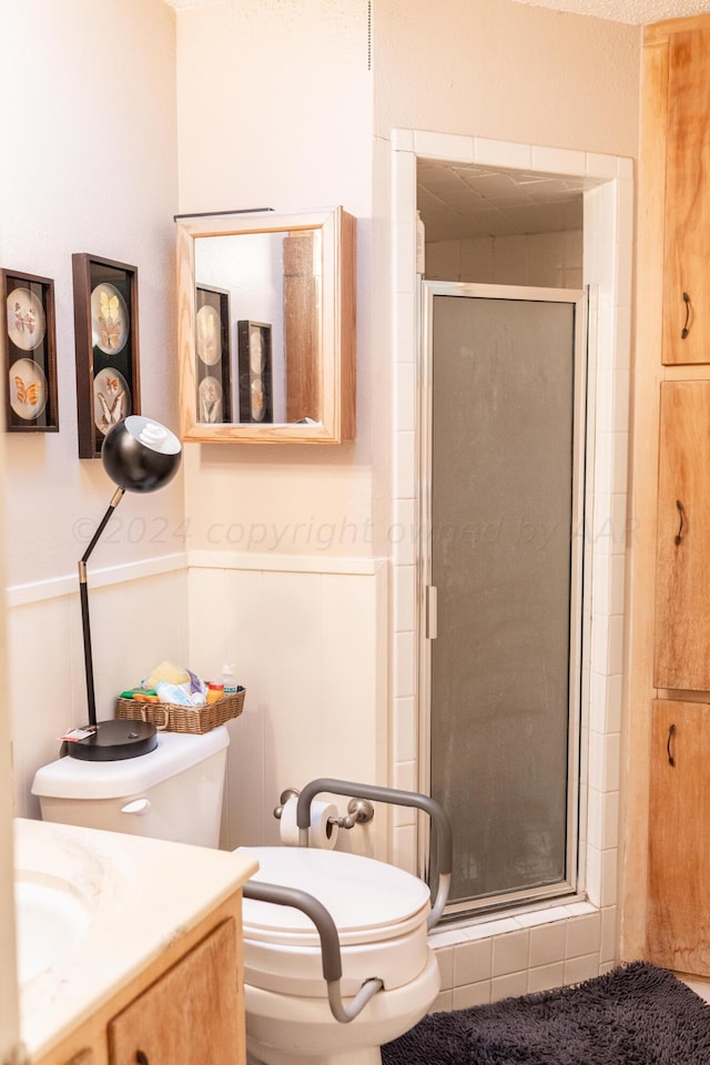 bathroom featuring walk in shower, vanity, and toilet