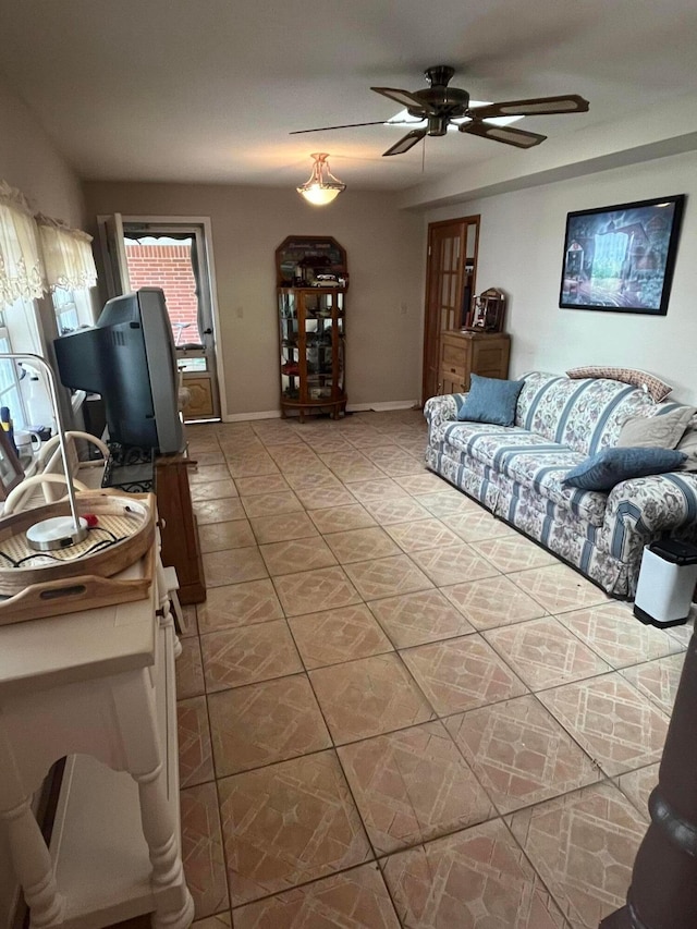 tiled living room featuring ceiling fan