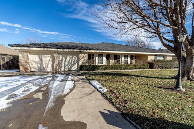 ranch-style home featuring a garage and a front lawn