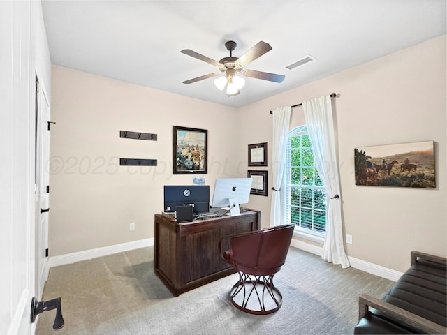 office space featuring visible vents, baseboards, ceiling fan, and carpet floors