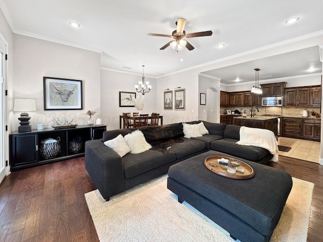 living room featuring crown molding, ceiling fan with notable chandelier, recessed lighting, and wood finished floors