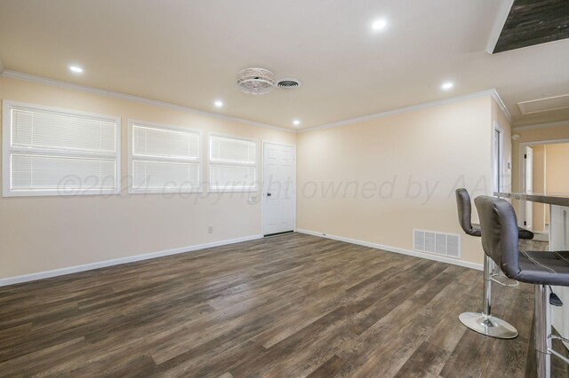 unfurnished office featuring dark hardwood / wood-style flooring and ornamental molding