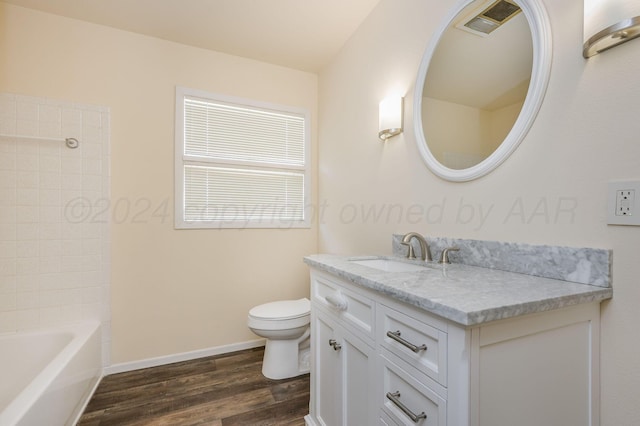 bathroom with vanity, wood-type flooring, and toilet