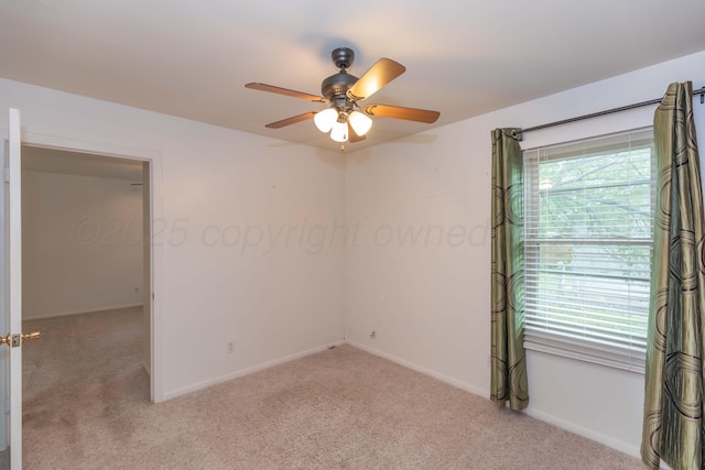 unfurnished room featuring baseboards, ceiling fan, and carpet