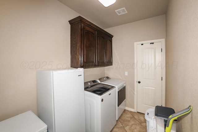 18150 19th St, Amarillo, TX 79124 - washroom featuring washing machine and clothes dryer, cabinet space, and light tile patterned floors