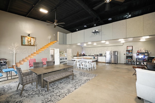 18150 19th St, Amarillo, TX 79124 - dining space featuring a high ceiling, finished concrete floors, stairway, and a ceiling fan