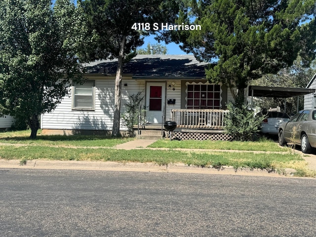 view of front of house featuring a porch and a carport